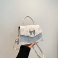 White mini crossbody bag with light pink butterfly prints and silver bow buckle strap - Pink