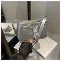 Metallic silver shoulder bag detail with drawstring design and gold eyelet accents - Silver
