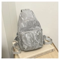 Detail of silver pleated fabric and metallic zippers on this compact crossbody chest bag - Silver