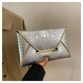 Detail of silver crocodile pattern envelope clutch with gold metal clasp and glossy finish - Silver