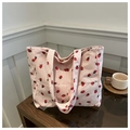 Detail of pink corduroy tote bag with red strawberry pattern and magnetic clasp closure - Pink