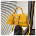 Detail of bright yellow crossbody bag with gold buckle and matching mini coin purse - Yellow