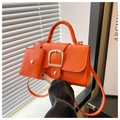 Close-up of bright orange lychee pattern crossbody bag with a gold buckle and small pouch - Orange