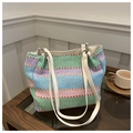 Detail of colorful woven shoulder bag with striped pattern and white leather straps - Green