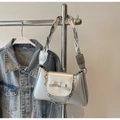 Detail of silver metallic handbag with bow accent and decorative flower chain - Silver