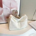 Minimalist cream shoulder bag with wrinkled texture and woven rope zipper detail - White