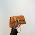 Minimalist tan leather crossbody bag with golden T-bar lock and chain strap - Brown