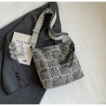Black and white striped canvas tote with wide strap and fringe tassel charm detail - Black