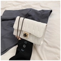 White quilted chain shoulder bag featuring a stylish golden clover-shaped buckle detail - White