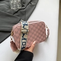 Pink monogram crossbody bag with wide patterned shoulder strap and gold hardware - Pink