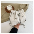 White butterfly studded bucket bag with drawstring closure and silver chain strap - White