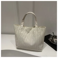 Detail of cream white tote bag featuring vertical pleated texture and spacious design - Brown