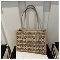 Detailed view of checkered wool tote bag with premium leather handles and trim - Khaki