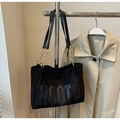Detail of matte black tote bag featuring HOOTO lettering and gold chain shoulder strap - Black