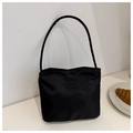 Close-up of black nylon shoulder bag featuring white pretty and libety embroidery - Black