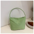 Minimalist light green nylon handbag with embroidery for women in a lifestyle setting - Green