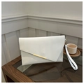 Detail of white leather clutch bag with asymmetrical flap and gold metal trim on a desk - White