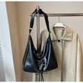 Detail of black glossy leather hobo bag with corset lace-up design and golden eyelets - Black without Pendant