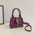 Fashionable purple leopard print crossbody bag with gold V-hardware and tassels - Purple