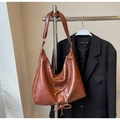 Detail of a brown faux leather hobo bag with lace-up cross strap and fringe decoration - Brown No Pendant