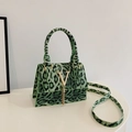 Green leopard print crossbody bag with gold V logo and metallic fringe details - Green