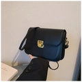 Detail of minimalist black crossbody bag showing the golden square push-lock closure - Black
