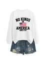 Close-up of No Kings In America 1776 print on white sweatshirt with denim shorts - White (Black Graphics)