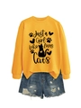 Close-up of bright yellow sweatshirt featuring Just a Girl Who Loves Cats graphic print - Yellow (Black Font)