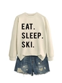 Flat lay of cream crewneck sweatshirt with black Eat Sleep Ski text and denim shorts - Sand (Black Font)