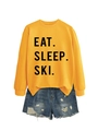 Detail of yellow sweatshirt with EAT SLEEP SKI text and distressed denim shorts - Yellow (Black Font)