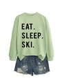 Flat lay of light green crew neck sweatshirt with EAT SLEEP SKI text and ripped denim shorts - Olive Green (Black Font)