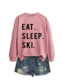 Close-up of pink Eat Sleep Ski sweatshirt paired with distressed denim shorts - Rose Gold (Black Font)