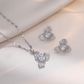 Silver titanium necklace set with zircon floral pendants on luxury white silk background - Clover Zirconia Jewelry Set (X1685/E278)