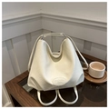 Detail of minimalist beige hobo bag with embossed logo and soft leather texture - White
