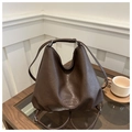 Detail of dark brown lychee textured tote bag with embossed logo on an elegant table - Brown