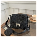 Detail of black pleated shoulder bag featuring a large silver metal butterfly and small pouch - Black