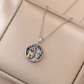 Hollow tree of life necklace with blue crystal and gold girl pendant on a jewelry box - Tree Of Life Necklace (With Pendant)