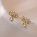 Elegant gold bow earrings with micro-set zircons and a teardrop crystal pendant - Gold Bowknot Earrings