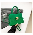Detail of green crocodile-embossed leather handbag with golden geometric buckle - Green