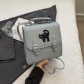Gray vintage backpack with black cat embroidery and double buckle straps in a lifestyle set - Cat Embroidery / Blue