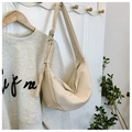 Detail of a creamy white crescent moon bag with metallic buckle and wide shoulder strap - Off White