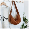 Detail of adjustable silver buckle and soft brown leather texture on hobo bag - Brown