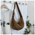Brown faux leather hobo bag with a wide strap and decorative silver eyelets - Brown