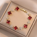Elegant gold bracelet with red four-leaf clover motifs and white zircon accents - Red Clover