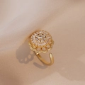 Golden sunflower open ring with shimmering cubic zirconia on soft beige silk - J103 Gold Rotating Sunflower Ring