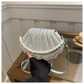 Detailed view of silver shell-shaped bag with pearl handle and quilted texture fabric - Silver