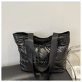 Detail of black quilted puffer tote bag in shiny nylon with soft padded texture - Black