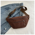 Flat lay of brown corduroy waist bag with adjustable strap and dual zippers on denim background - Brown
