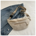 Detail of beige corduroy waist bag showing double zipper pockets and soft ribbed texture - Khaki
