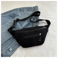 Detail of black corduroy chest bag with textured fabric and two zipper compartments - Black